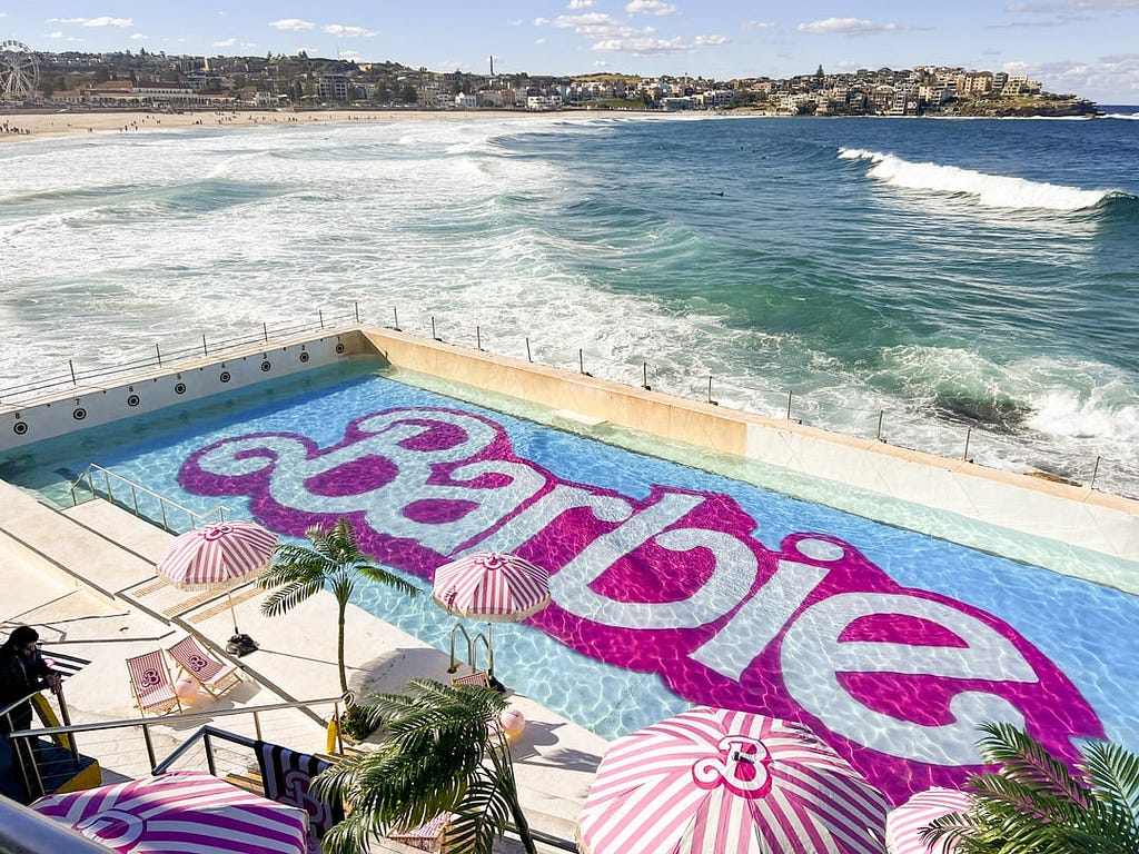 Bondi Icebergs Swimming Club in Sydney, Australia — with the bottom of the pool replaced with a Barbie movie logo and release date.