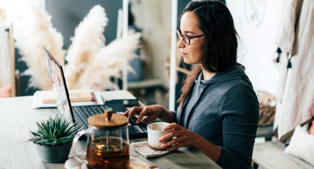 An entrepreneur working while drinking tea