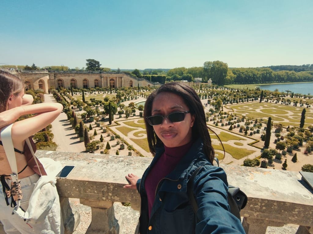 Two women taking a selfie at the palace of versailles.