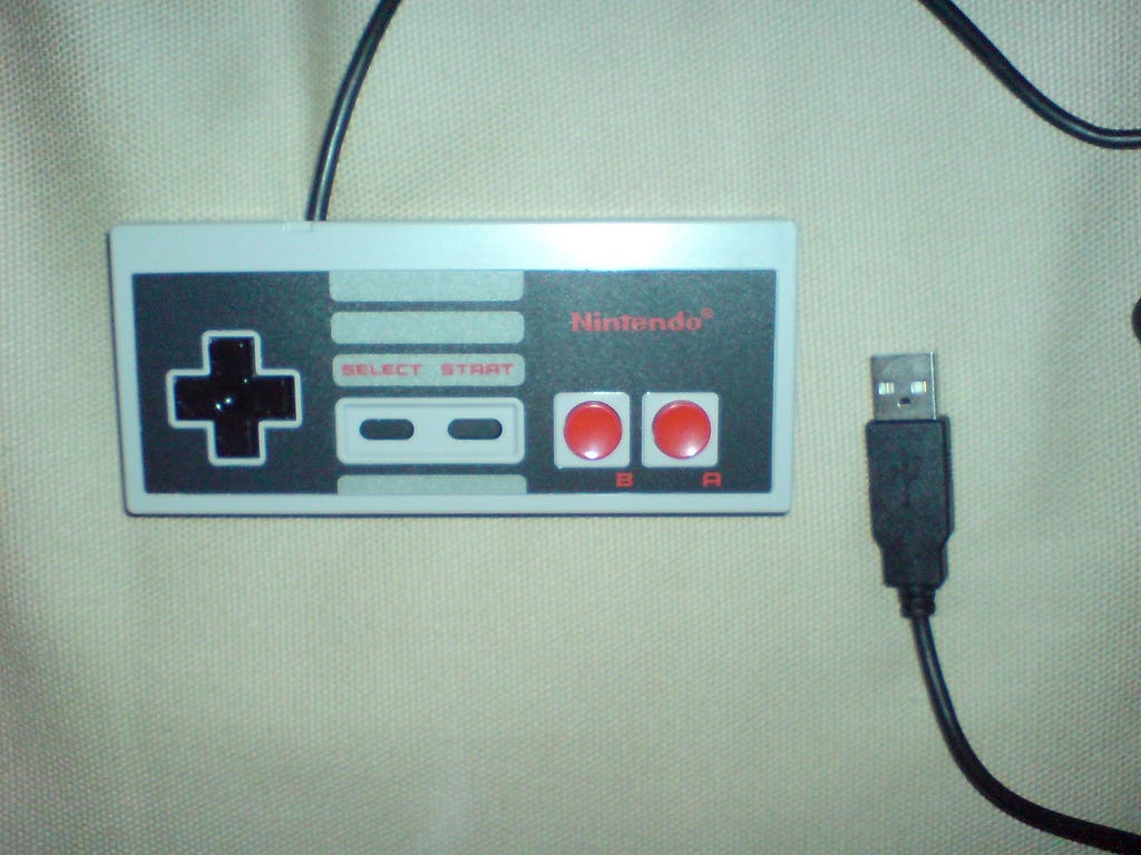 A NES controller with a USB cable and connector.