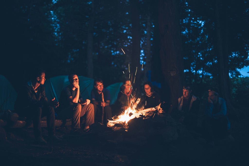 7 campers around the campfire at night- telling stories!