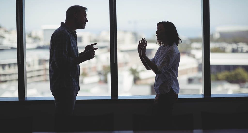 Business partners arguing near window in office