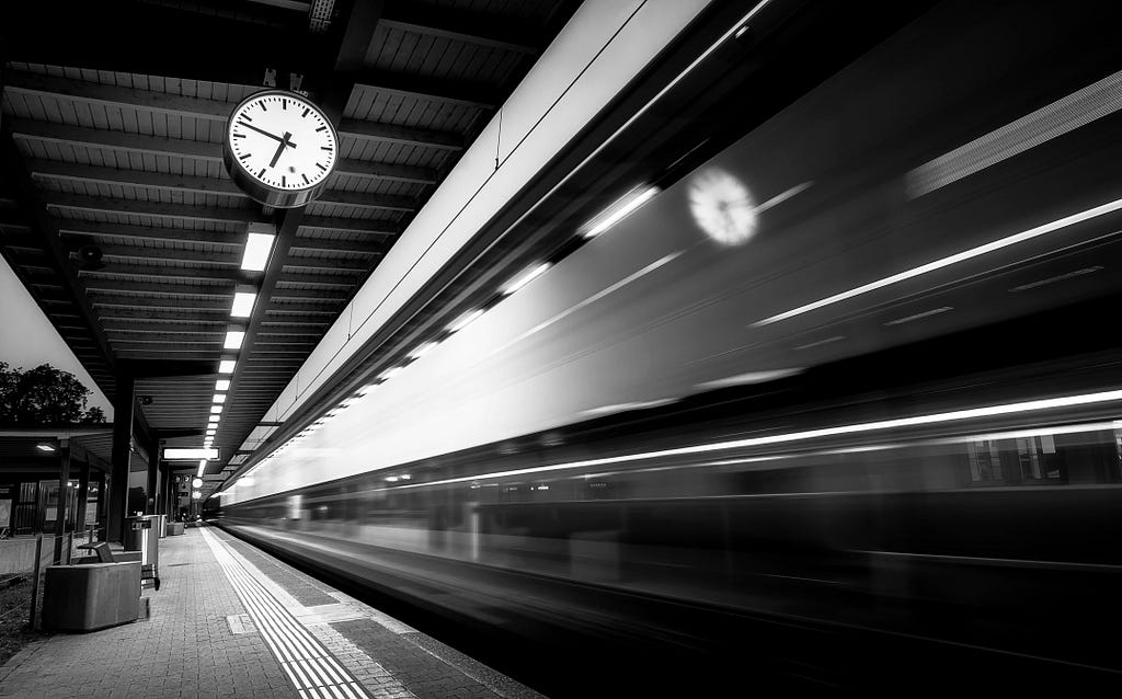 A picture of a moving train passing through a tunnel at very high speed. The picture depicts the passing of time.