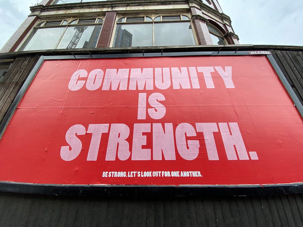 A poster depicting that community is strength