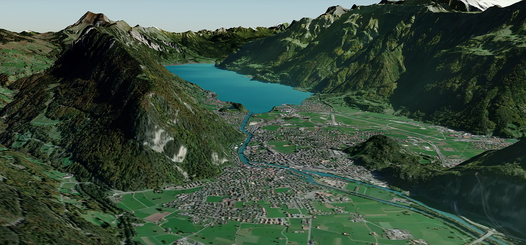 A 3d map of Interlaken, Switzerland. The town sits in a valley, alongside a blue lake