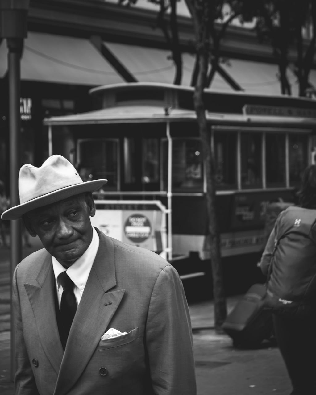 a black and white photo of an older man dressed smartly