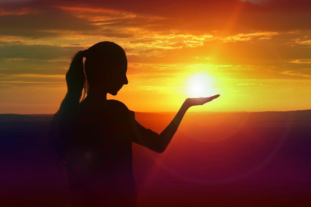 Photo of woman to look like she is holding the sun by Rampal Singh. Photo posted on Dr. James Goydos 2021 article ‘summer is here, is your skin safe’