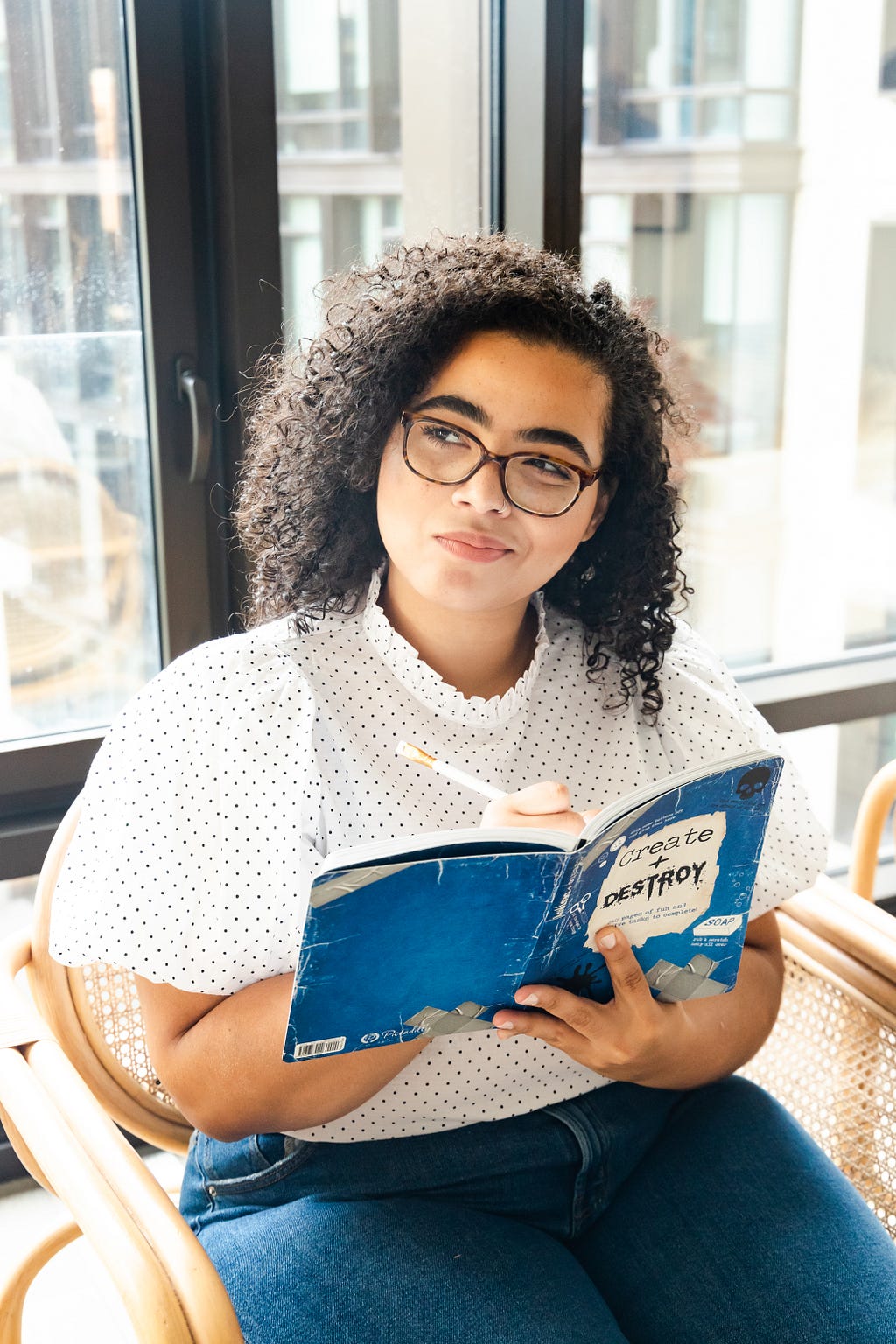 A femme presenting person pondering life while reading a book