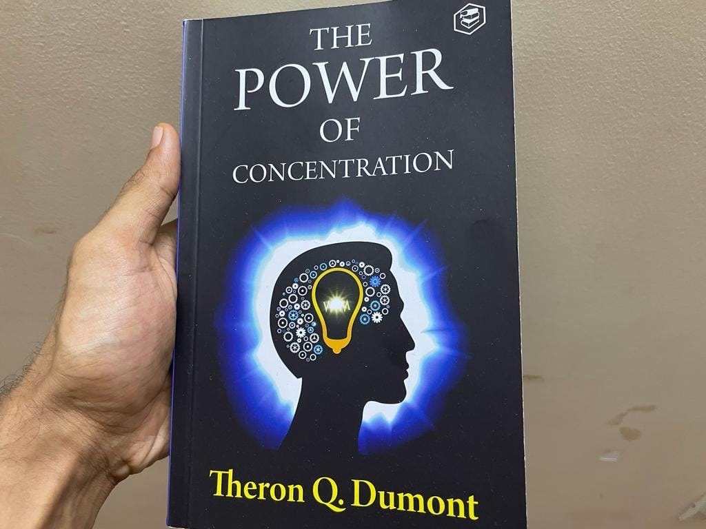 Photo of the author holding The Power Of Concentration paperback