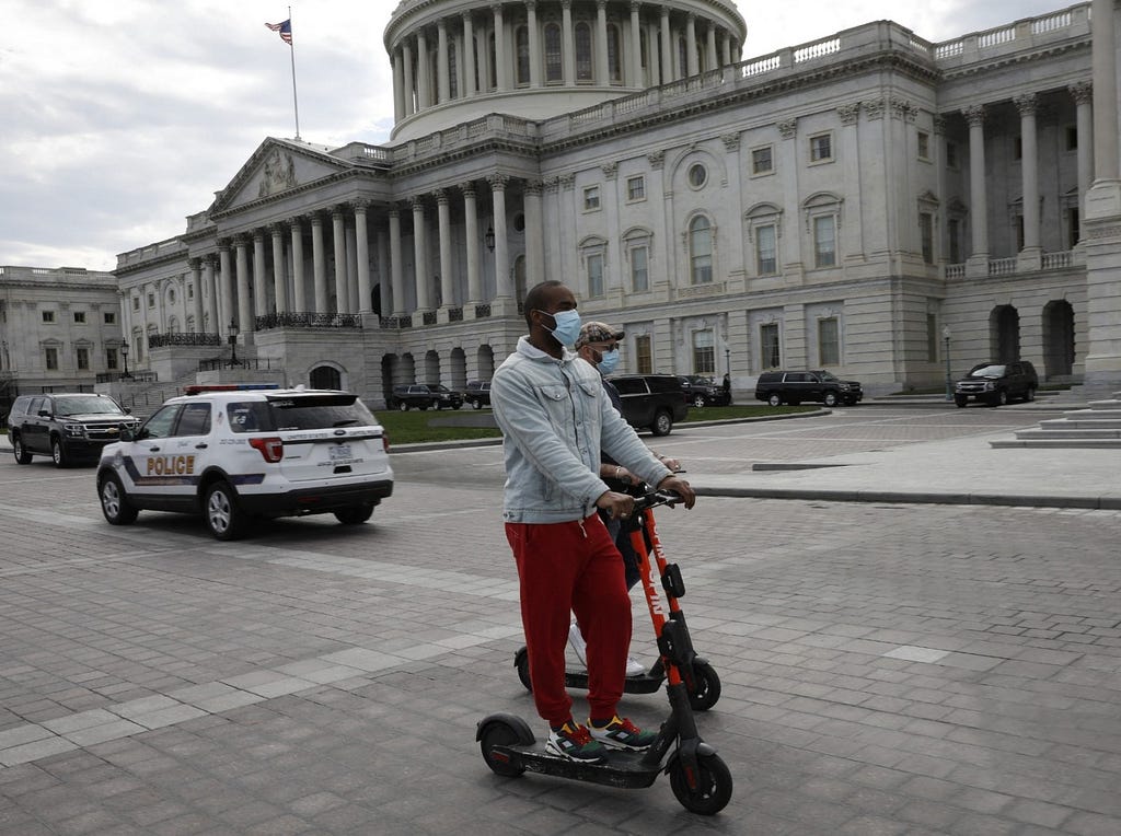 Two men ride electric scooters on Capitol Hill in Washington D.C., March 20, 2020. Photo by Gripas Yuri/ABACA via Reuters