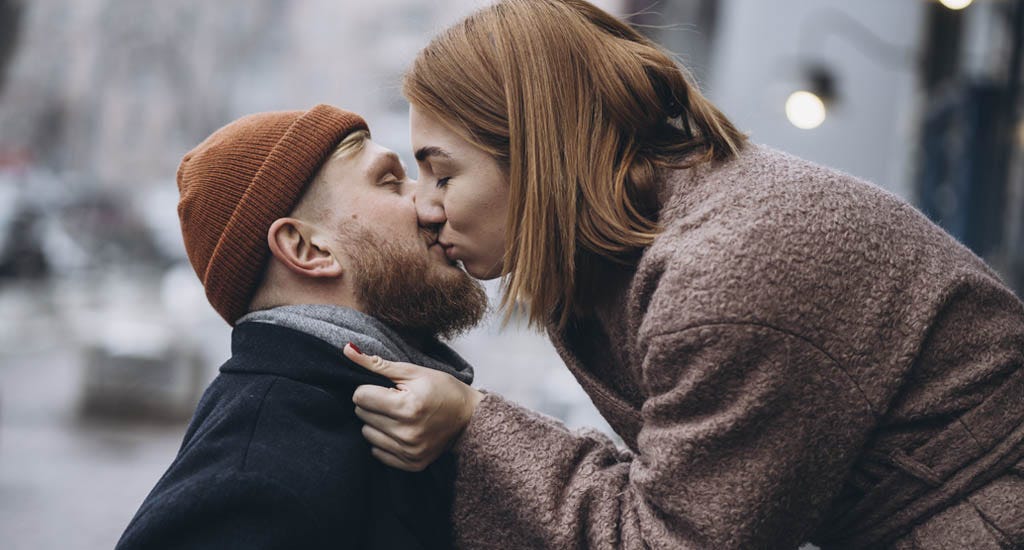 Adult loving couple kissing on the street