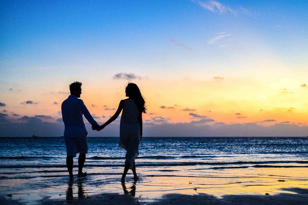 Couples walking on beach