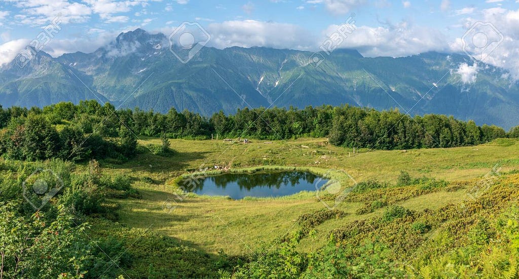 View Of A Mountain Glade With A Transparent Mirror Lake, And ...