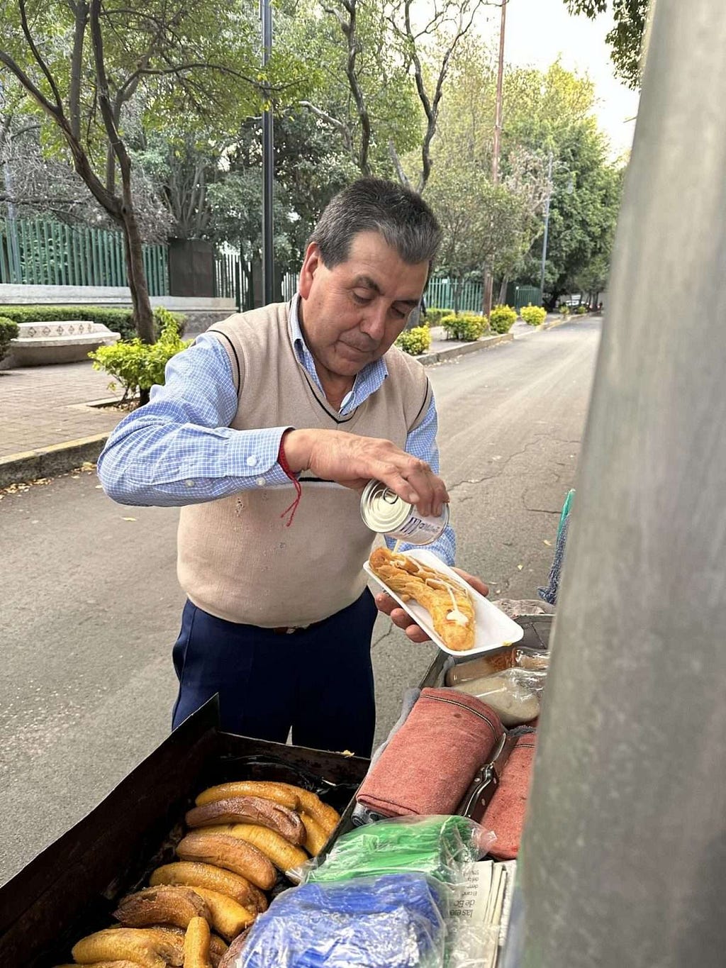 street vendor selling steamed plantains with sweetened condensed milk