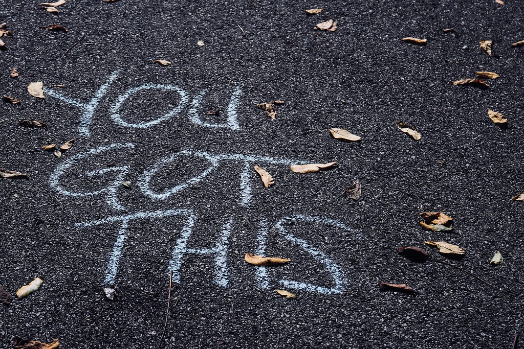 “You got this” written with chalk on the floor