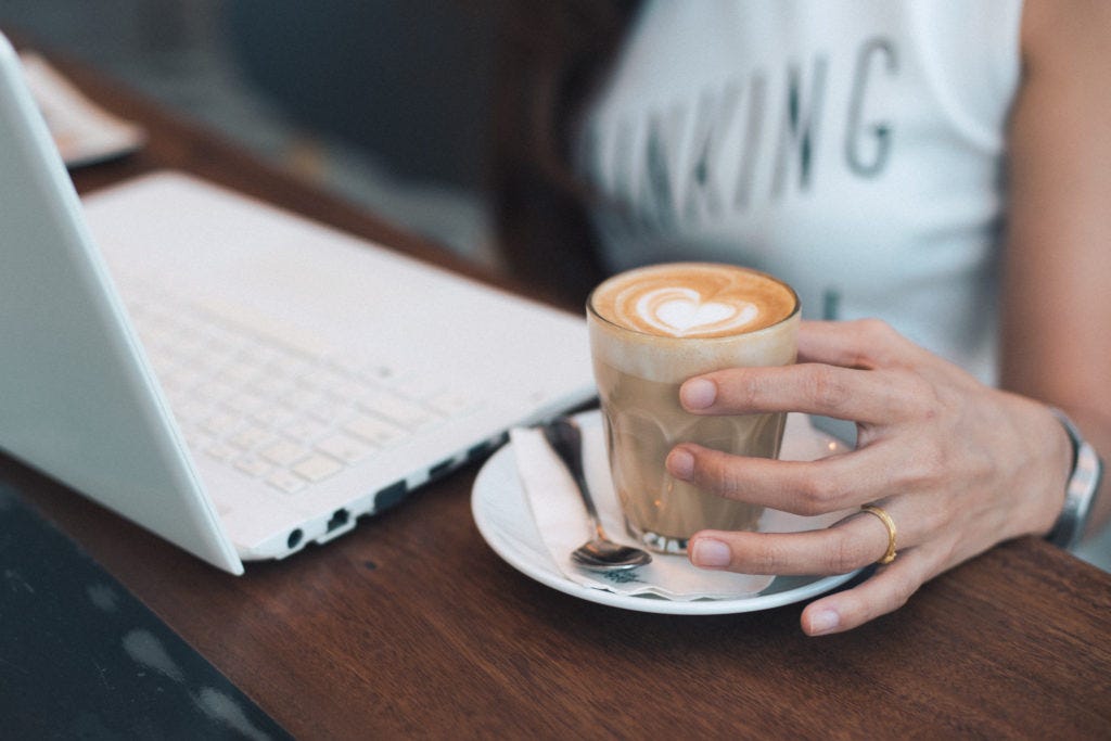 woman-with-coffee-and-laptop-working