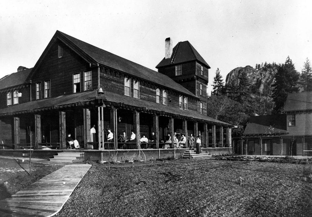 Tahoe Tavern constructed by DL Bliss in 1902 located on the northwest shore. By 1909 the hotel could accomodate 450 guests. Black and white photo.