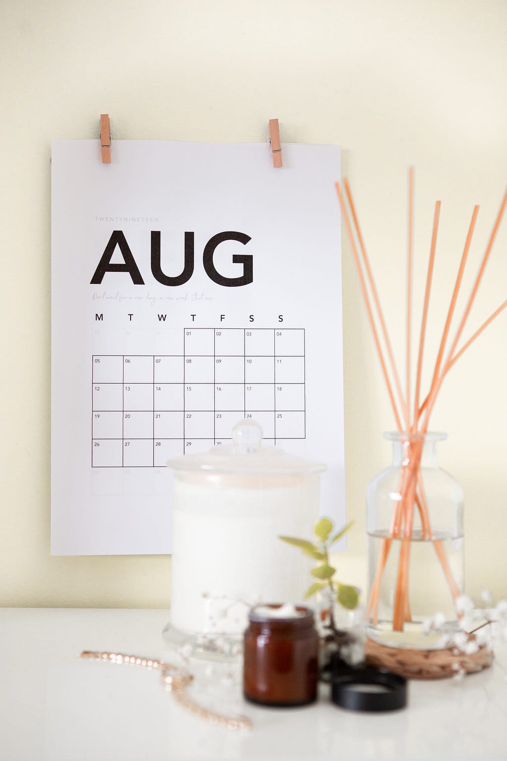 A wall calendar that reads “AUG” and displays the dates below.