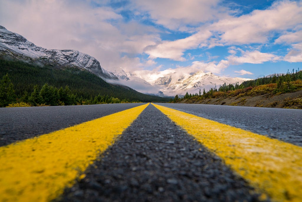 A photo of a mountain road stretching into the distance
