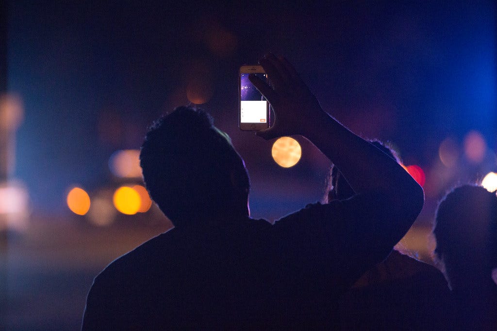 From creator: “Someone livestreams using their phone across the street from where Minnesota Bureau of Criminal Apprehension (BCA) investigators process the scene of where a St. Anthony Police officer shot and killed 32-year-old Philando Castile in a car near Larpenteur Avenue and Fry Street in Falcon Heights, Minnesota, on July 6, 2016.”