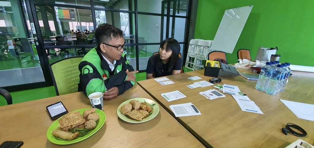 Picture of me interviewing Gojek driver for user journey study