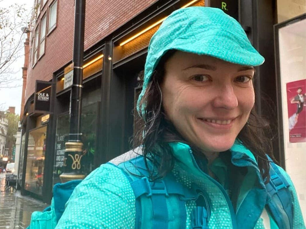 Photo of Hayley Ward, Director of User Research and Insight at Deliveroo, delivering food in the rain