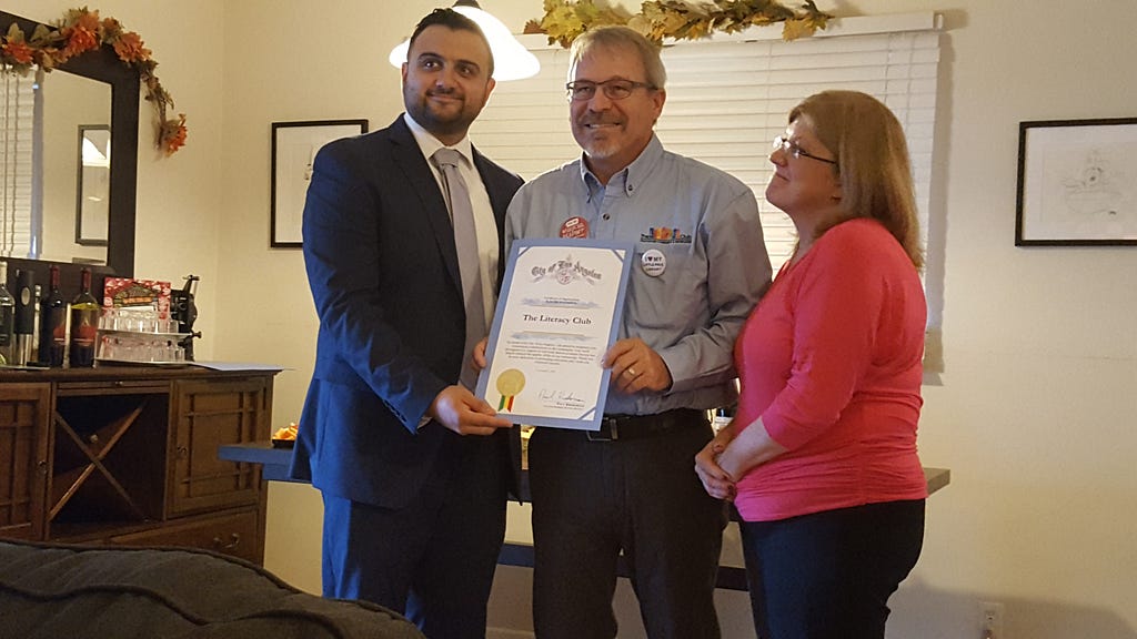 Sahag Yedalian representing Paul Krekorian's office presents a certificate of appreciation from the City of Los Angeles to Jean and Doug Chadwick for their work on The Literacy Club's behalf.