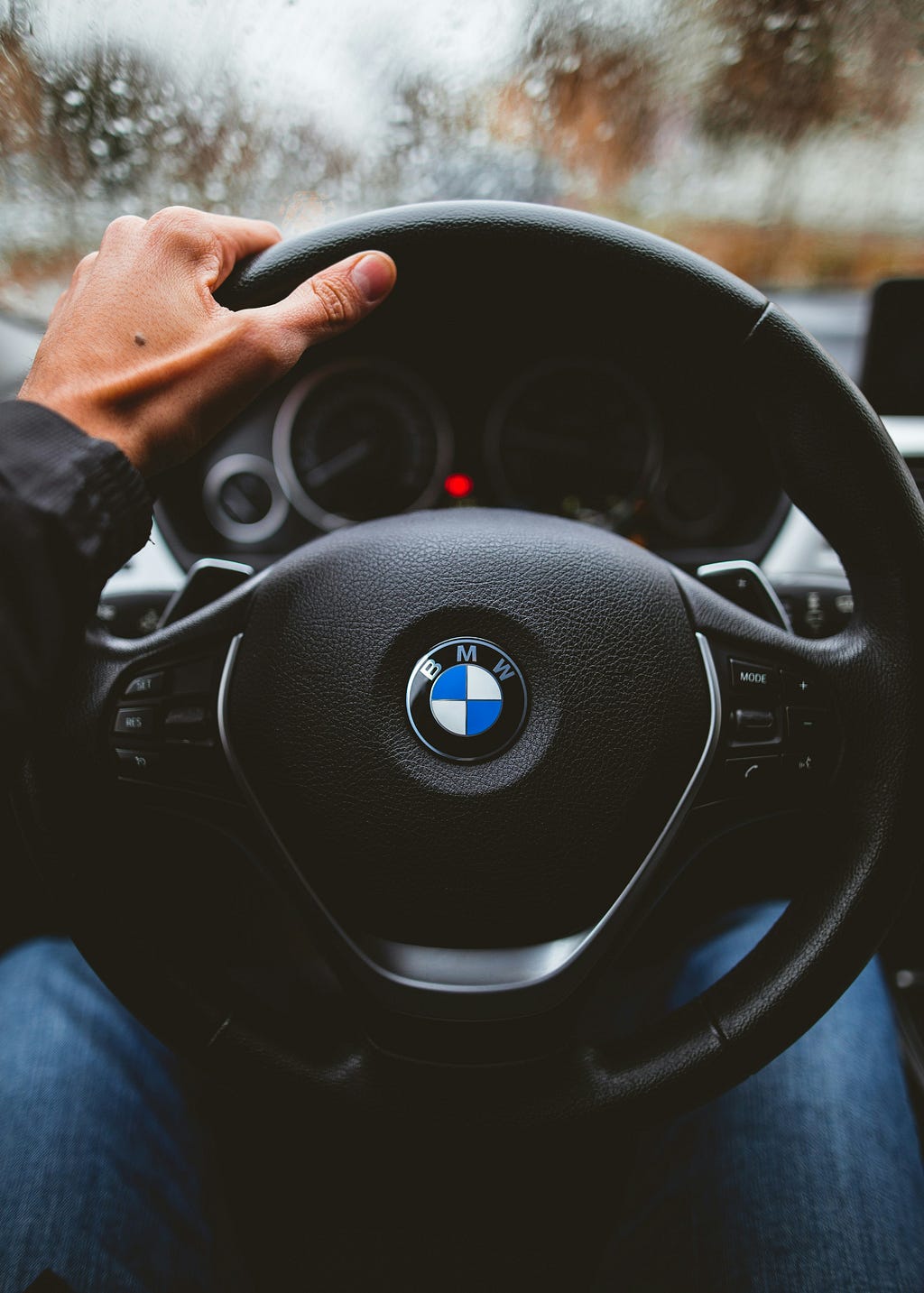 Hands on a BMW steering wheel