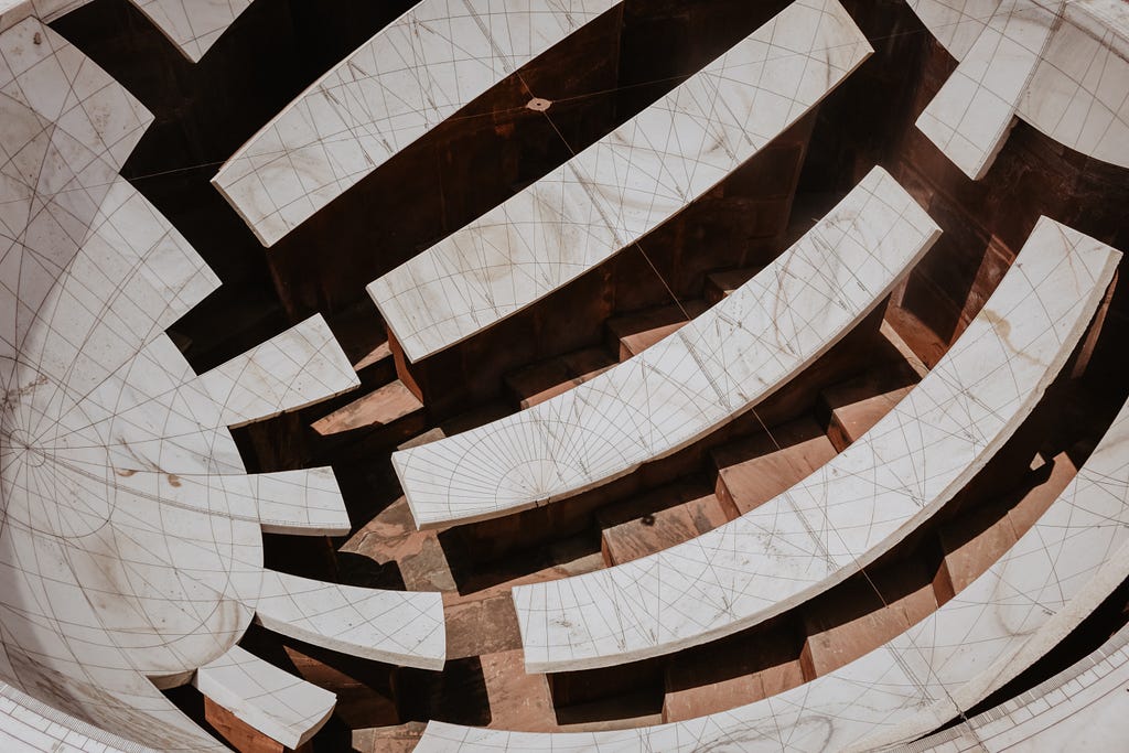 Jai Prakash Yantra — two hemispherical bowl-based sundials with marked marble slabs that map inverted images of sky. It allows the observer to measures altitudes, azimuths, hour angles, and declinations.