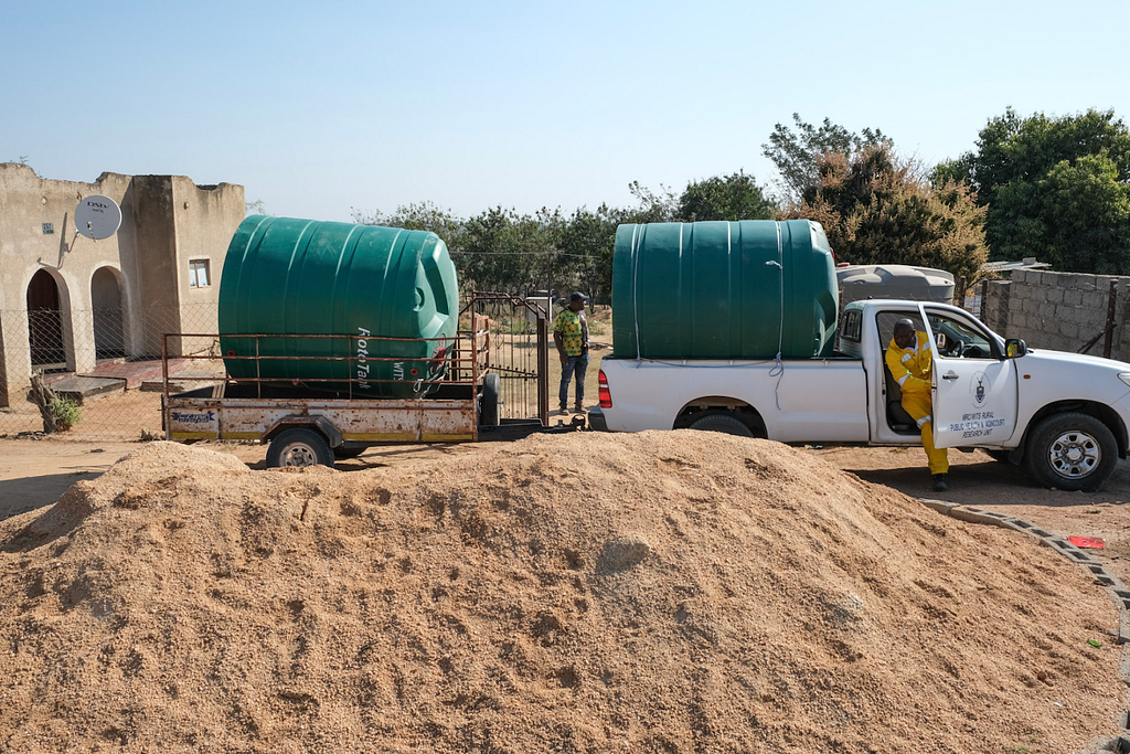 Simon driving the water tanks to a community in Agincourt.