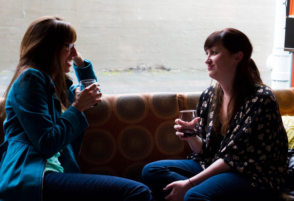 Karla Swan, left, and Caitlin Thorpe enjoy a glass of wine at Vinostrology on West Holly Street in Bellingham. Bailey Barnard / Klipsun Magazine 