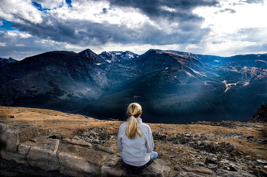 Woman sitting on a mountain