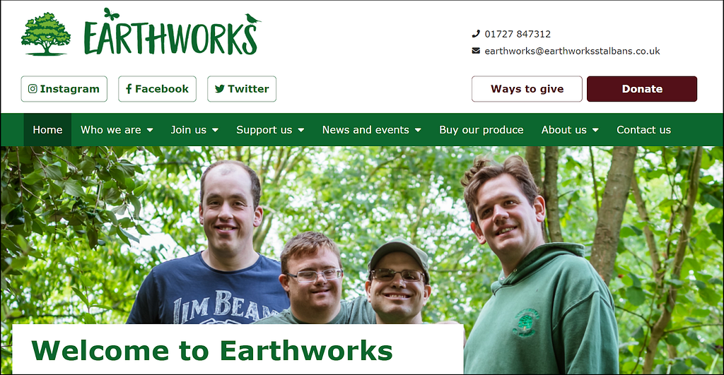 A screenshot of the new Earthworks homepage. It has 4 white male Earthworkers smiling at the camera against a backdrop of green-leafed trees. Above them the logo says ‘Earthworks’ and there are menu items to lots of different places on the website. In the foreground a banner says ‘Welcome to Earthworks’