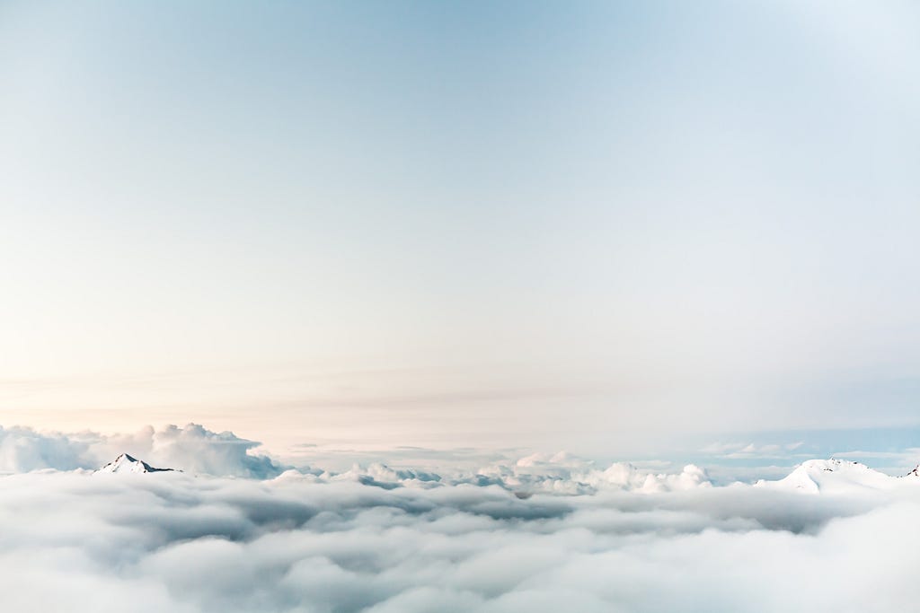 The white tops of clouds, then a clear light-blue sky