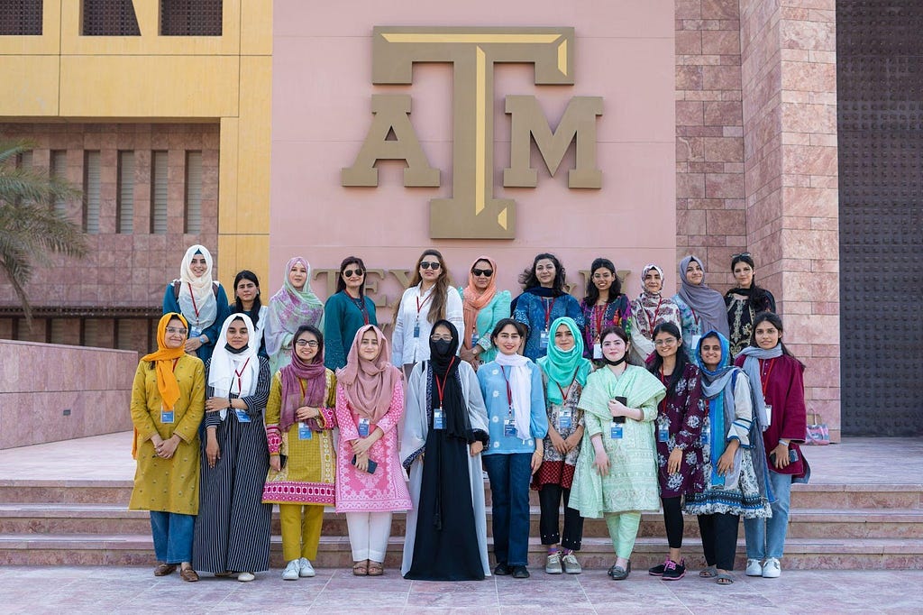 22 women pose for a photo outside of Texas A&M