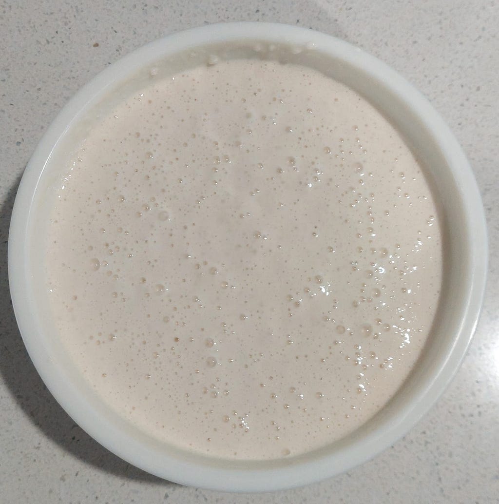 Fermented Masa batter in a bowl, ready to be fried.