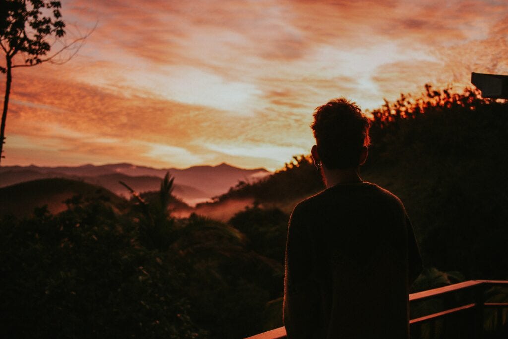 man watching sunset