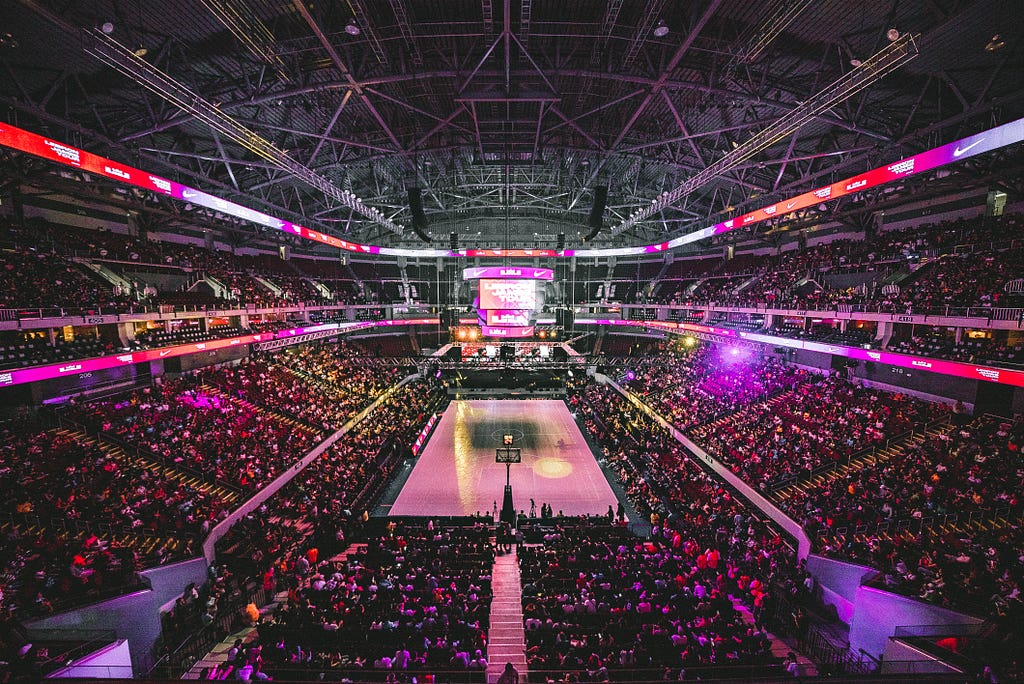 Photo of an basketball arena with a crowd