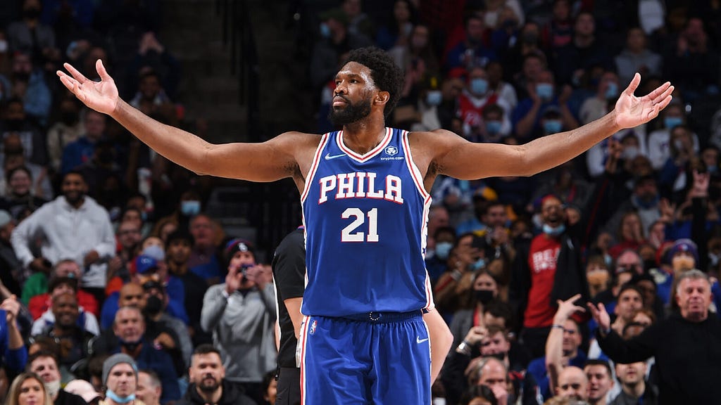 Joel Embiid holding his arms out in celebration