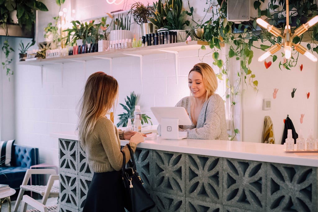 Image of a receptionist helping a customer