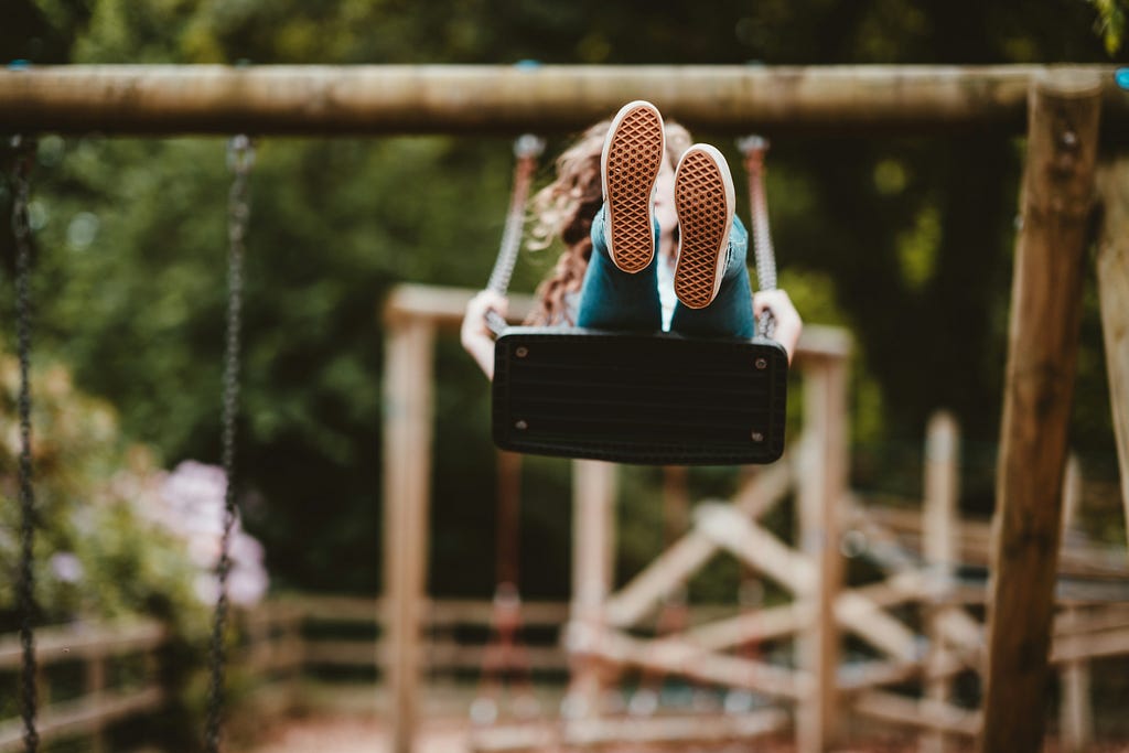 A child playing on the swing.