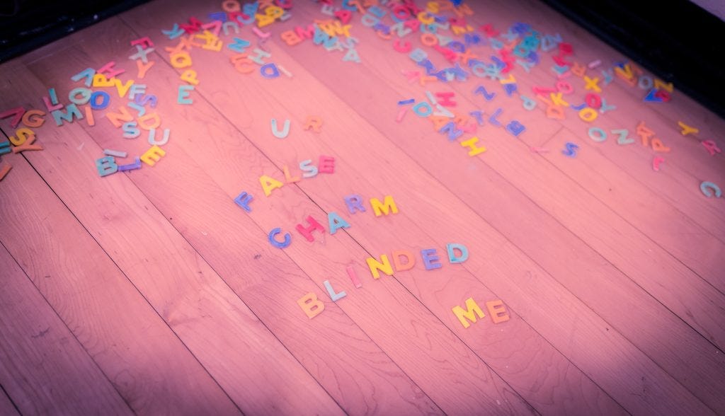 Claudia Solorzano: Ceramic letters in the corner of the room. Visitors were welcome to write with the letters, but Solorzano herself also wrote a phrase each day. Here is the Wednesday phrase, "UR False Charm Blinded Me"