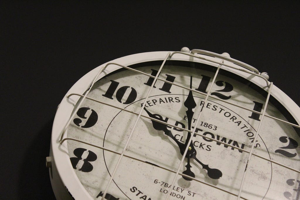 Photo of a clock with a dark background.