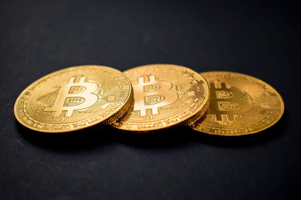 Three bitcoins aligned horizontally