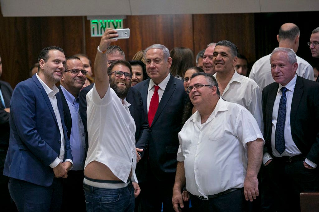 A picture of Knesset member Oren Hazan taking a selfie with Israel’s Prime Minister Benjamin Netanyahu along with a bunch of other Israeli politicians.