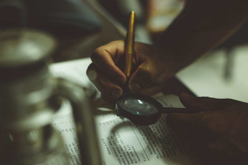 Magnify glass being used to look at words on a page.