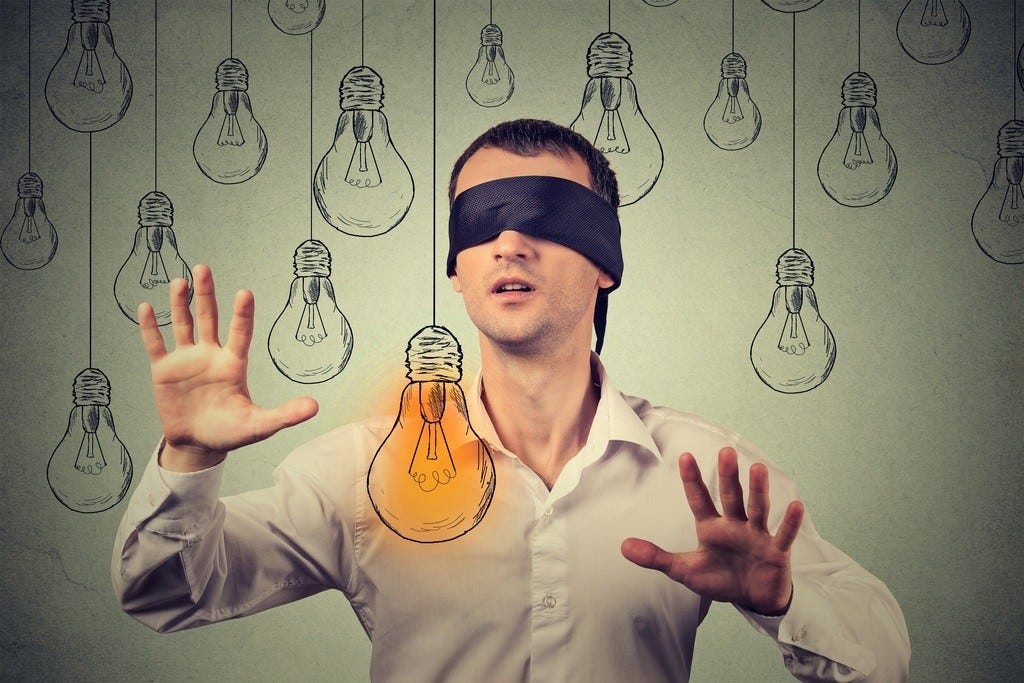 blindfolded man with lightbulb