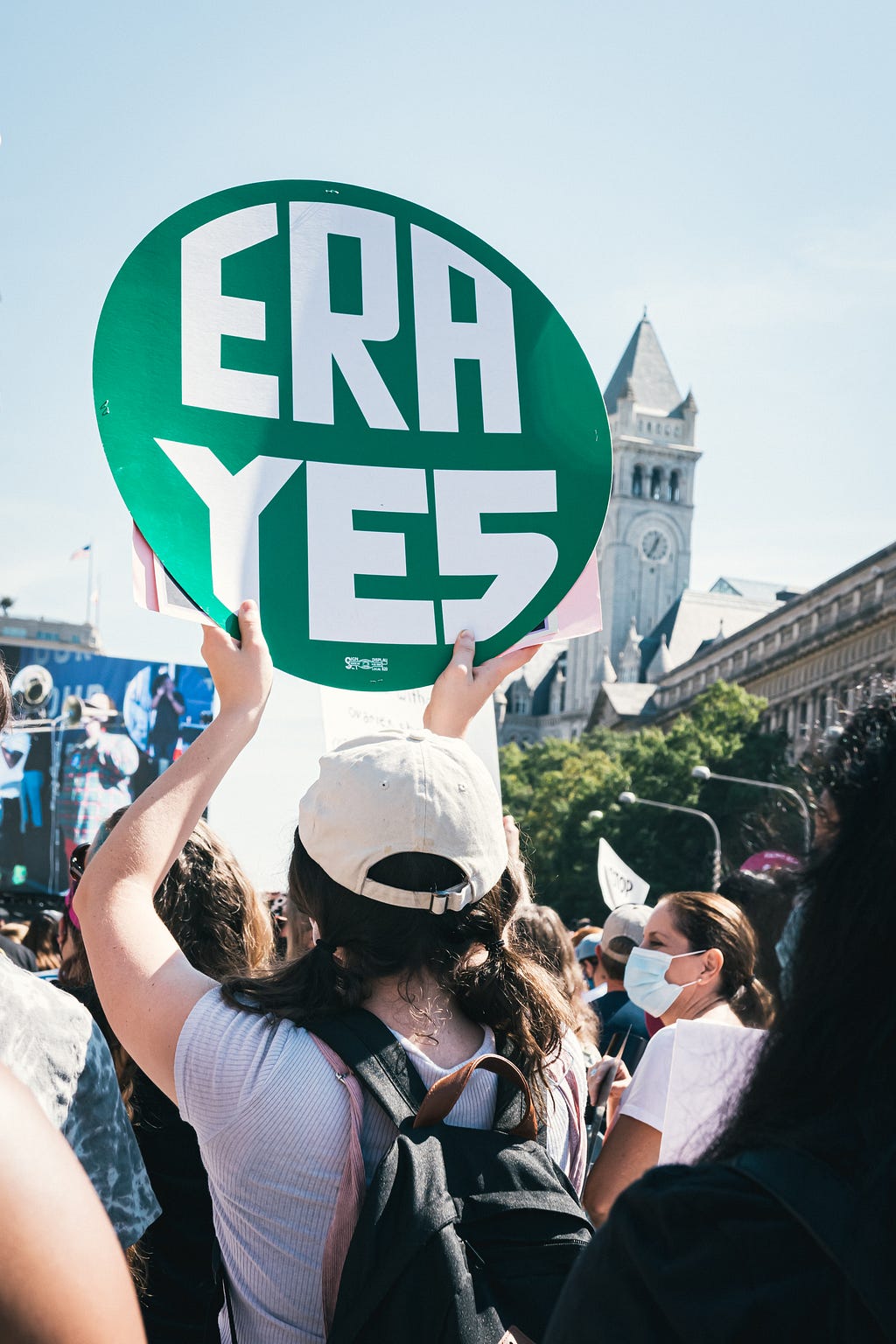 A billboard saying, ‘Era Yes’ in the hands of a man in a crowded protest.