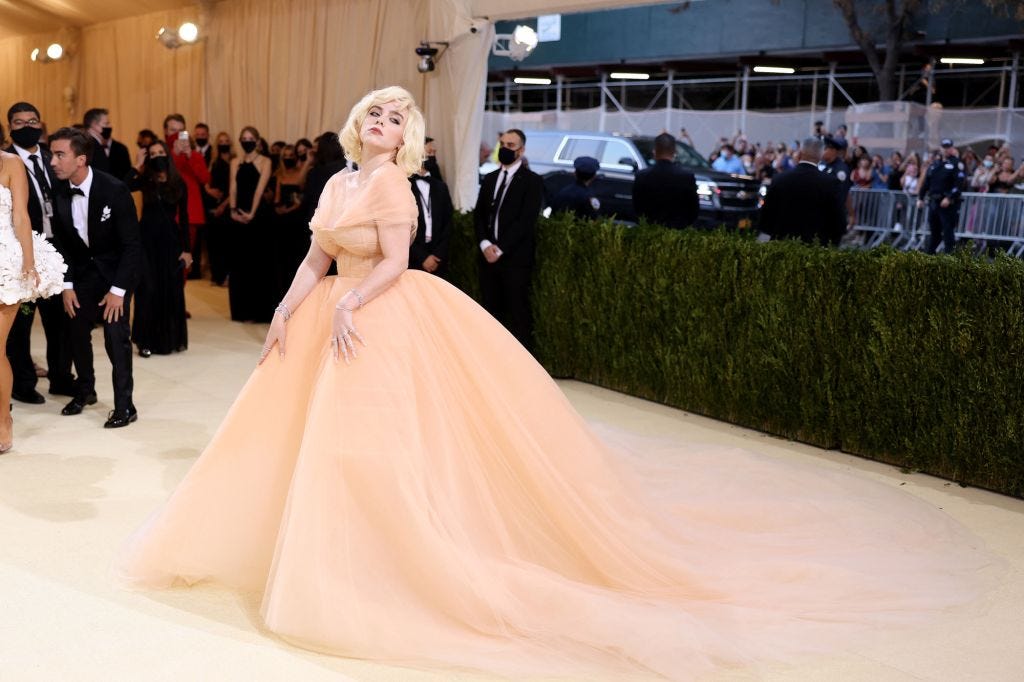 Billie Eilish wearing a peach ballgown at the entrance of the Met.