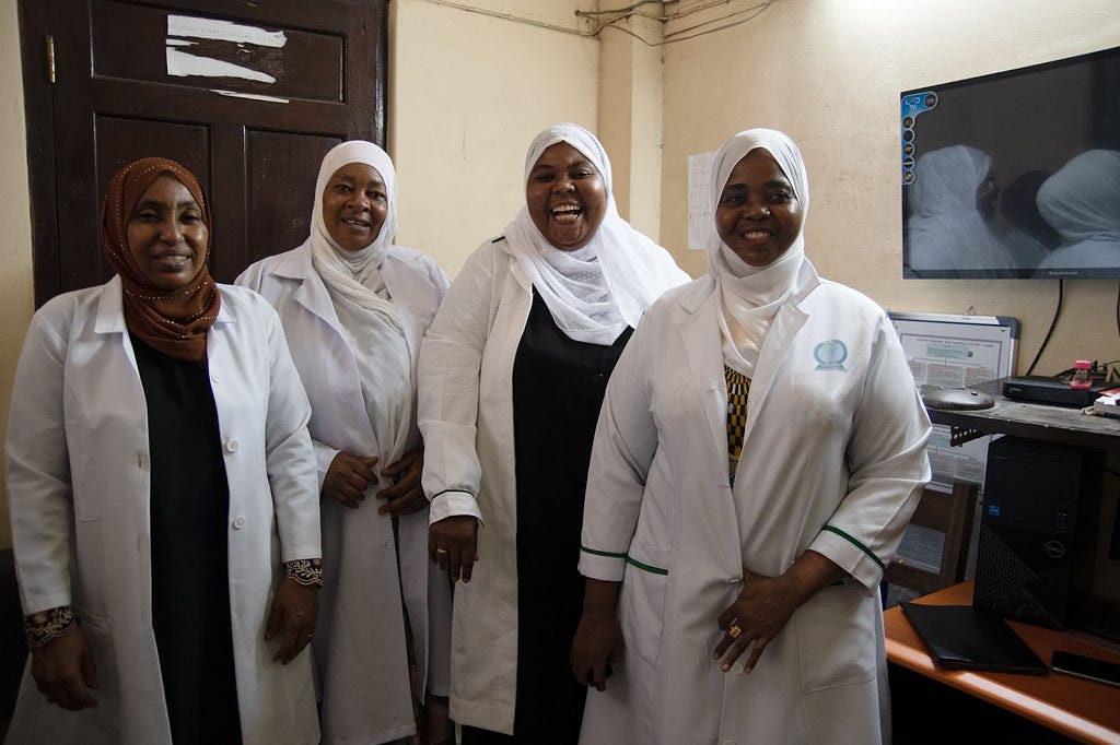 Four dispatchers pose for a picture in the Unguja Dispatch Center in Zanzibar.